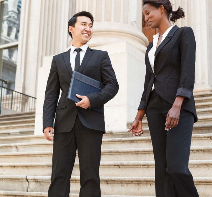 Business people in front of government building.