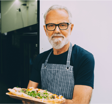 Chef baking pizza