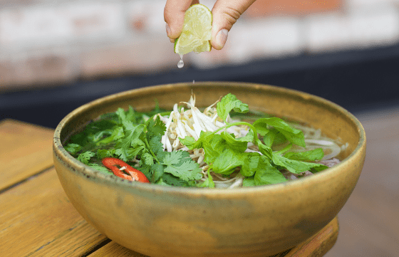 Squeezing lime over ramen