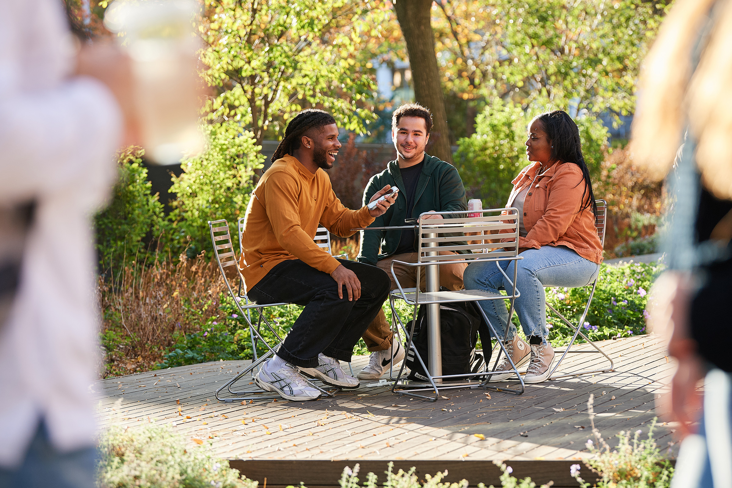 A group of college students talking and laughing while eating.
