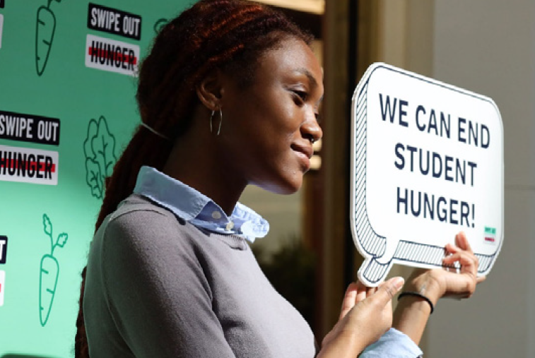 Student holding up sign.